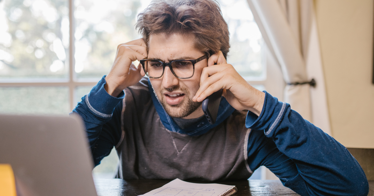 man looking confused at his laptop.